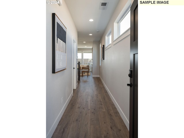 corridor with dark hardwood / wood-style flooring