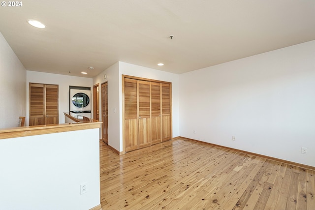 interior space featuring light hardwood / wood-style floors and stacked washing maching and dryer