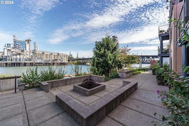 view of patio / terrace with a water view and a fire pit