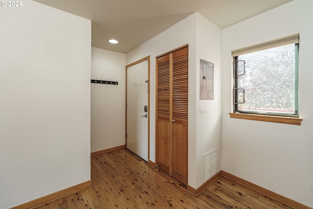 hall featuring electric panel and hardwood / wood-style floors