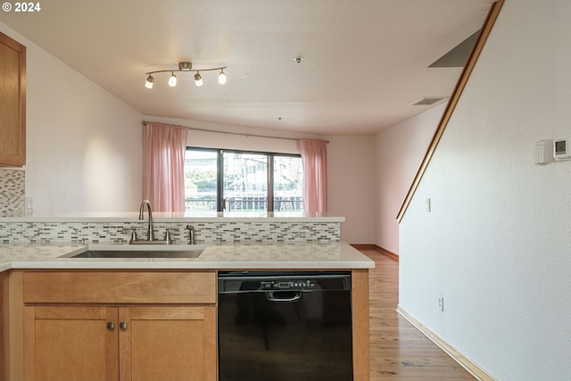 kitchen featuring decorative backsplash, dishwasher, light hardwood / wood-style flooring, and sink