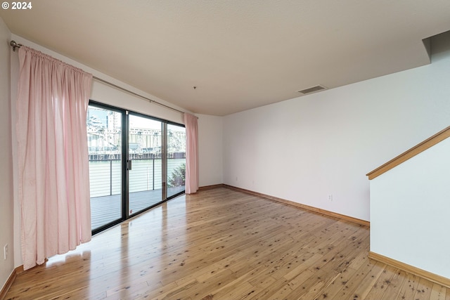 spare room with light hardwood / wood-style flooring