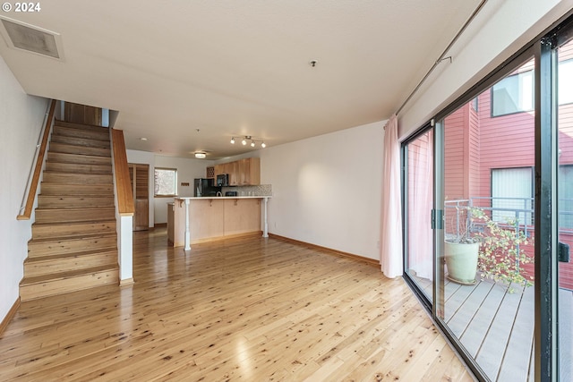 unfurnished living room with light hardwood / wood-style floors