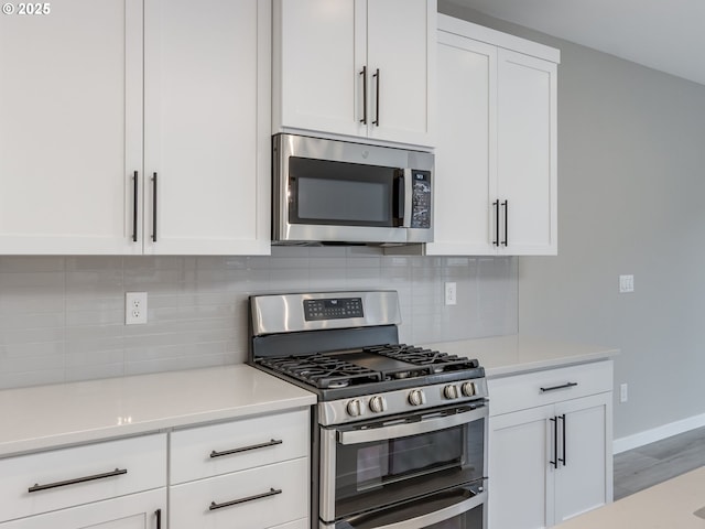 724 NW 178th Way, Ridgefield, WA 98642 - kitchen with stainless steel appliances, white cabinets, and light countertops