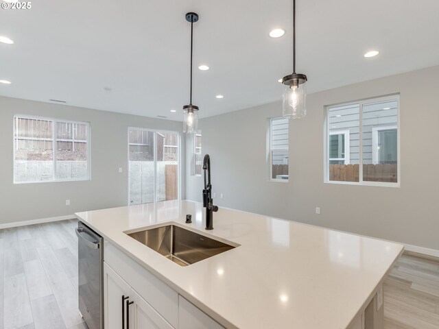 724 NW 178th Way, Ridgefield, WA 98642 - kitchen featuring a sink, recessed lighting, stainless steel dishwasher, decorative light fixtures, and light countertops