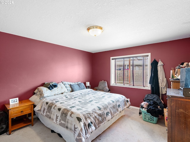 carpeted bedroom featuring a textured ceiling