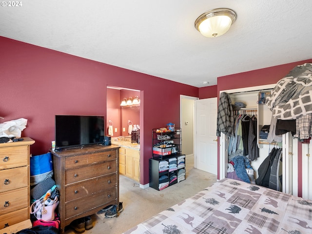 bedroom featuring ensuite bath, light carpet, and a closet