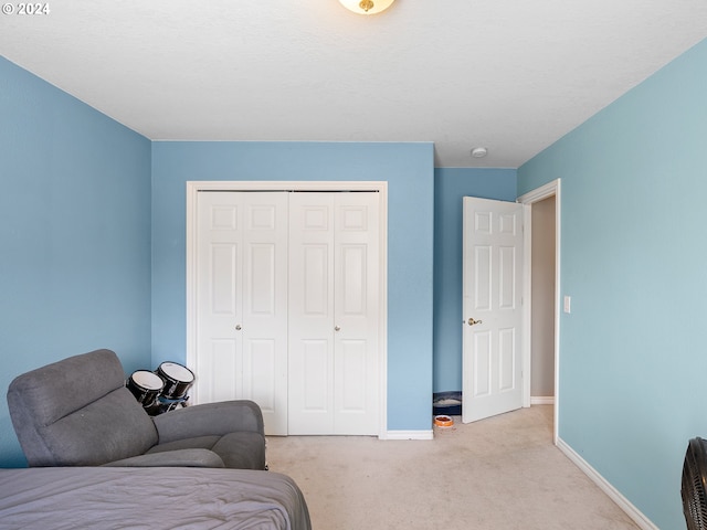 carpeted bedroom featuring a closet