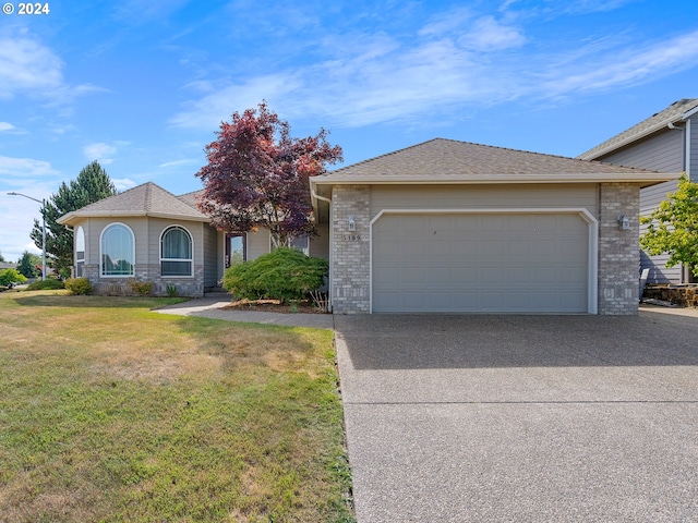 view of front of house with a garage and a front lawn