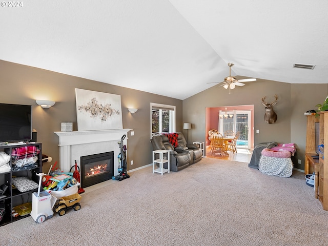 living room with carpet flooring, vaulted ceiling, and ceiling fan