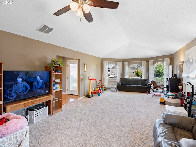 living room with carpet flooring, ceiling fan, and lofted ceiling