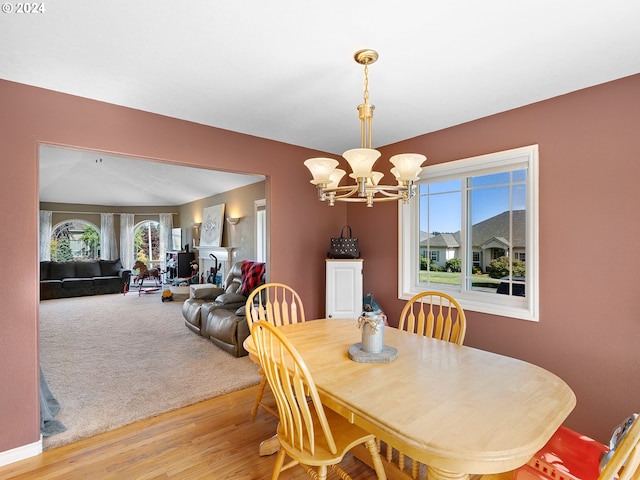 dining room featuring light wood-type flooring and a notable chandelier