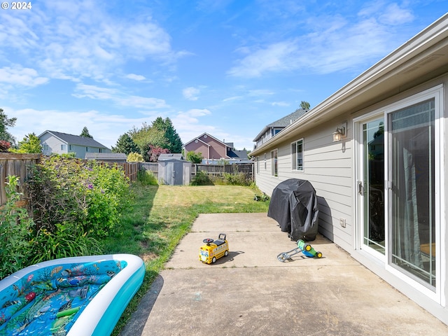 view of patio / terrace with area for grilling and a shed