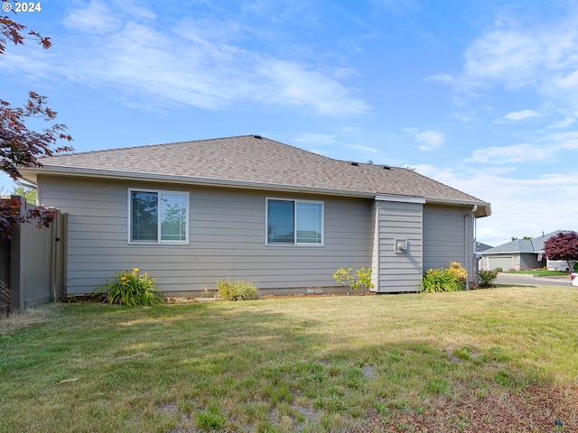 back of property featuring a yard