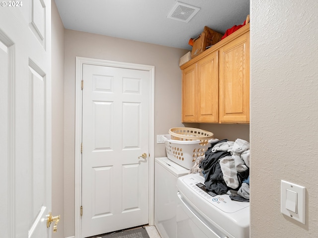 laundry area with cabinets and independent washer and dryer