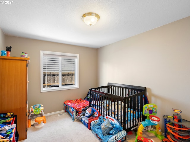 carpeted bedroom with a crib