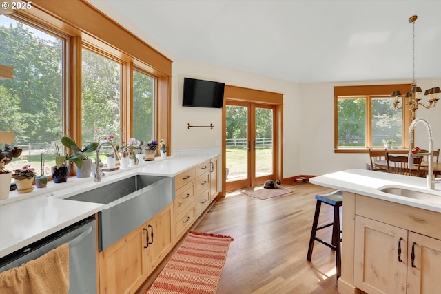 47266 SW Carpenter Creek Rd, Forest Grove, OR 97116 - kitchen with dishwasher, light brown cabinetry, light wood-style floors, and light countertops