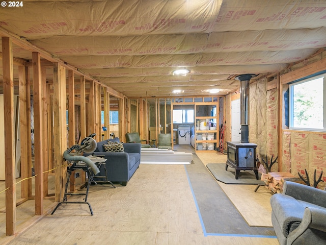 basement with a healthy amount of sunlight and a wood stove