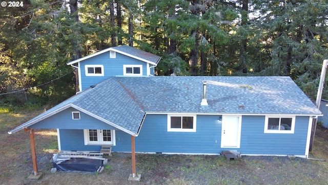 view of front facade with entry steps, crawl space, and a shingled roof