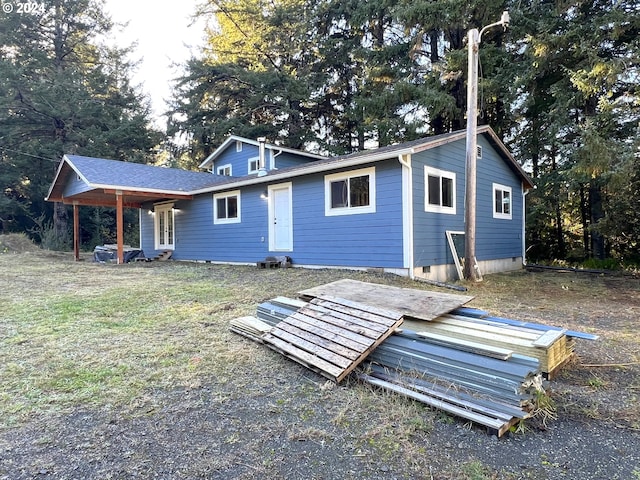 rear view of house featuring an attached carport