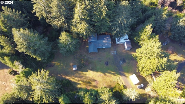 bird's eye view with a wooded view