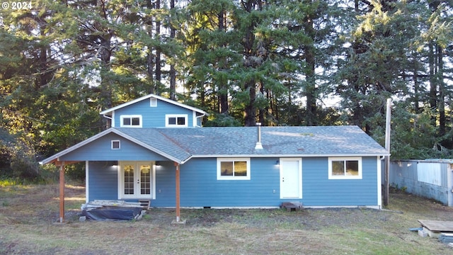 view of front of home with french doors and roof with shingles