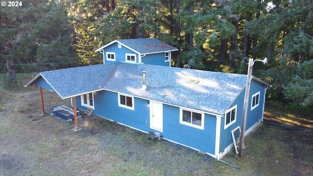 exterior space featuring french doors and roof with shingles