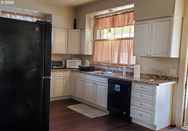 kitchen with sink, black appliances, dark hardwood / wood-style flooring, dark stone counters, and white cabinets