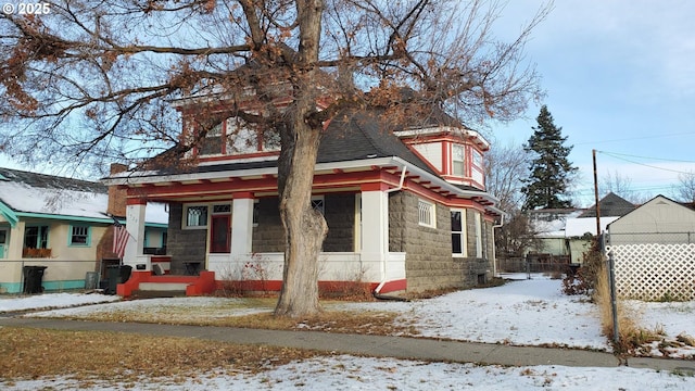 view of front of property with a porch and fence