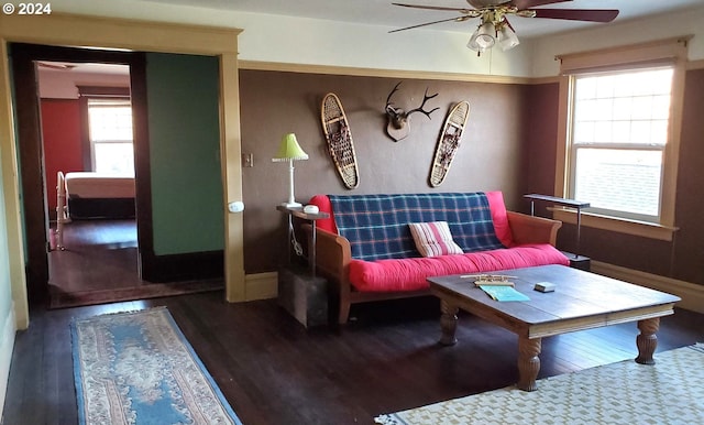 living room with dark hardwood / wood-style floors and ceiling fan