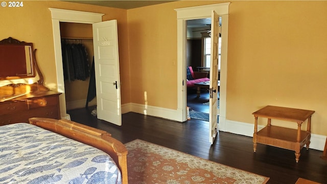 bedroom with dark hardwood / wood-style floors and a closet