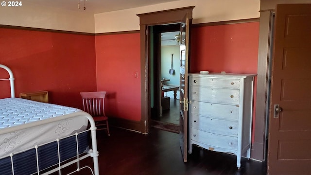 bedroom with dark hardwood / wood-style floors