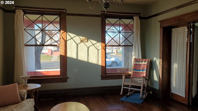 sitting room with wood-type flooring and a chandelier