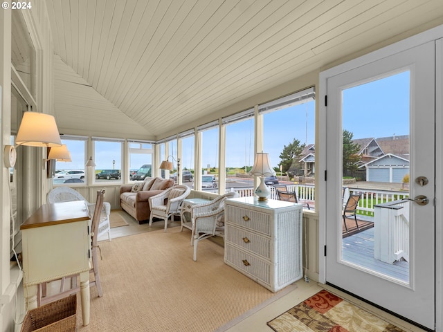 sunroom / solarium featuring vaulted ceiling, a wealth of natural light, and wooden ceiling