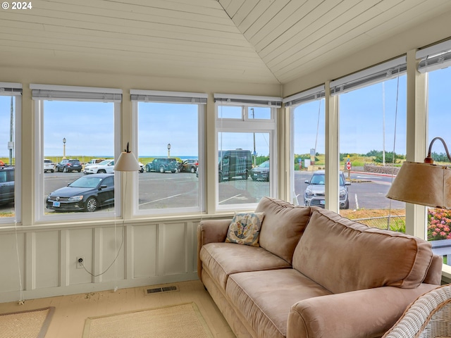 sunroom / solarium featuring lofted ceiling and wood ceiling