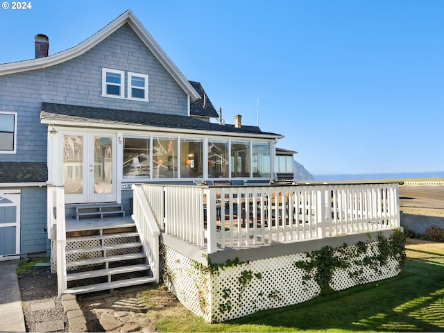 back of property with a wooden deck and french doors