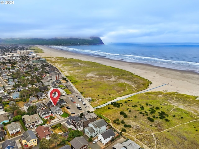 bird's eye view featuring a view of the beach and a water view