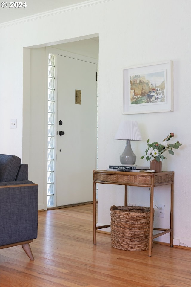 entrance foyer featuring light wood-type flooring and ornamental molding