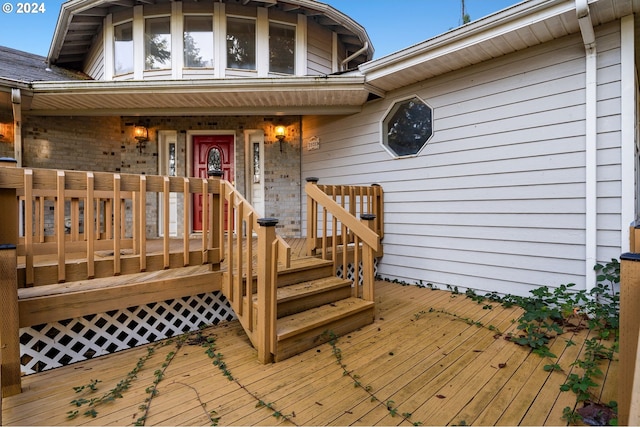 view of exterior entry featuring a wooden deck