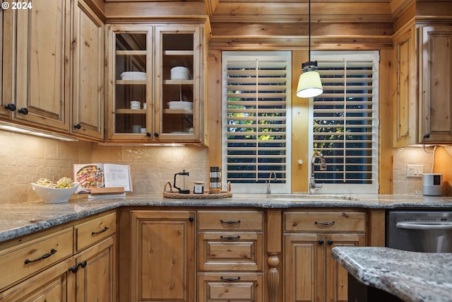 kitchen featuring sink, dishwasher, light stone countertops, decorative backsplash, and decorative light fixtures