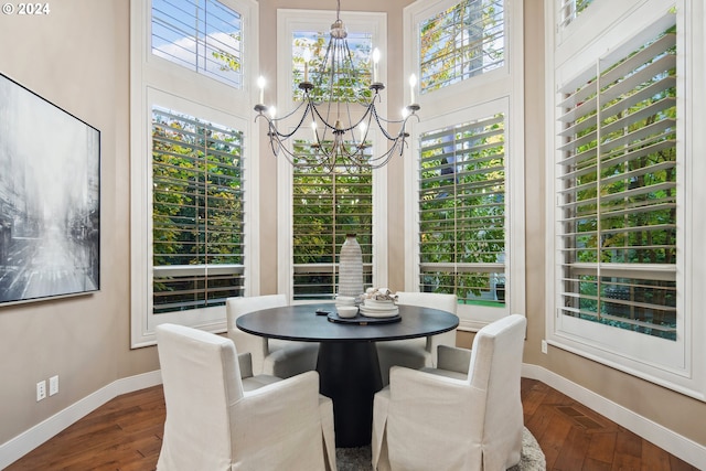 dining room featuring a towering ceiling, hardwood / wood-style floors, and a chandelier