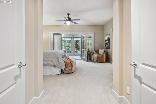 carpeted bedroom with french doors, ceiling fan, and access to outside