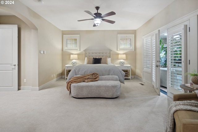 carpeted bedroom with ceiling fan and access to outside