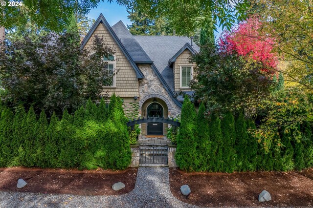 815 E Ave, Lake Oswego, OR 97034 - view of front of house with stone siding, a gate, and roof with shingles
