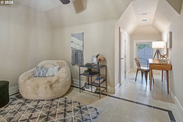 sitting room featuring ceiling fan, tile patterned flooring, and vaulted ceiling