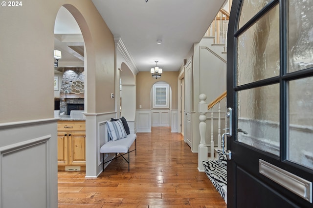 entryway featuring crown molding and light hardwood / wood-style flooring