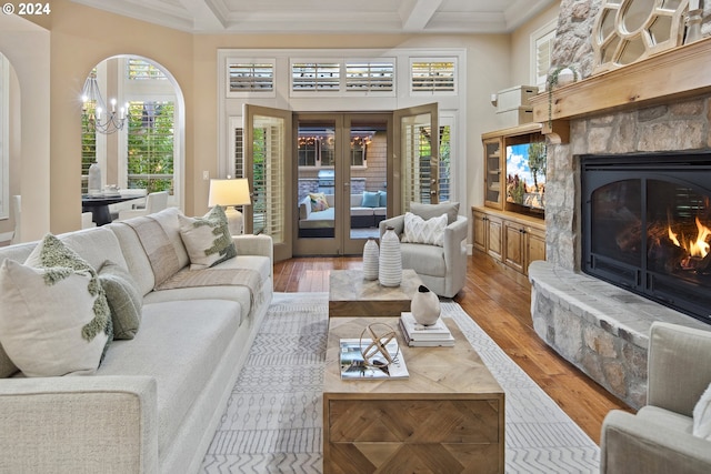 815 E Ave, Lake Oswego, OR 97034 - living area with crown molding, a fireplace, wood finished floors, french doors, and arched walkways
