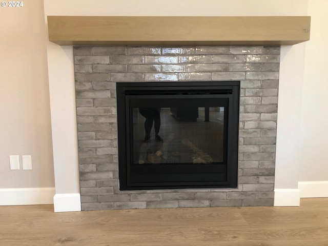 interior details featuring wood-type flooring and a fireplace