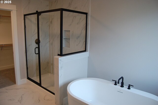 bathroom with separate shower and tub