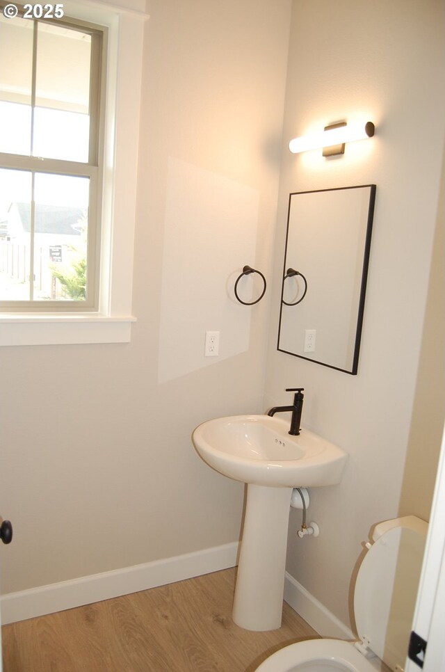 bathroom featuring hardwood / wood-style floors and toilet